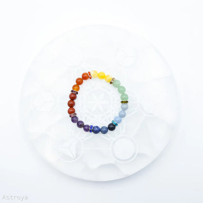 Bracelet 7 chakras | Pierres 9mm- sur pierre de chargement en sélénite - vue de dessus