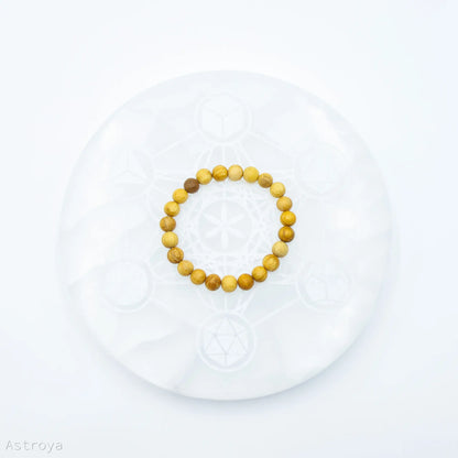 Bracelet Palo Santo perles rondes - 8 mm sur une pierre de rechargement