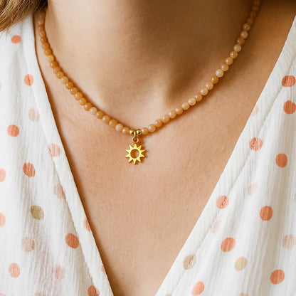Collier ajustable Pierre de soleil avec pendentif soleil porté par une femme
